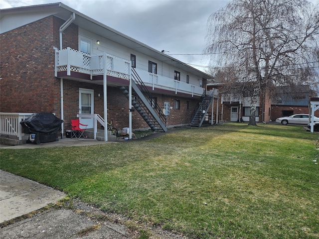 rear view of property with a lawn