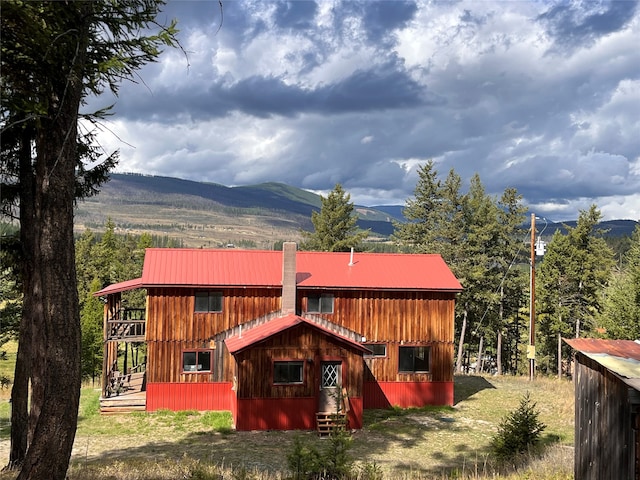 rear view of house featuring a mountain view