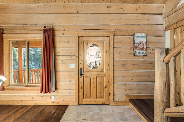 tiled entrance foyer with wood walls and wooden ceiling