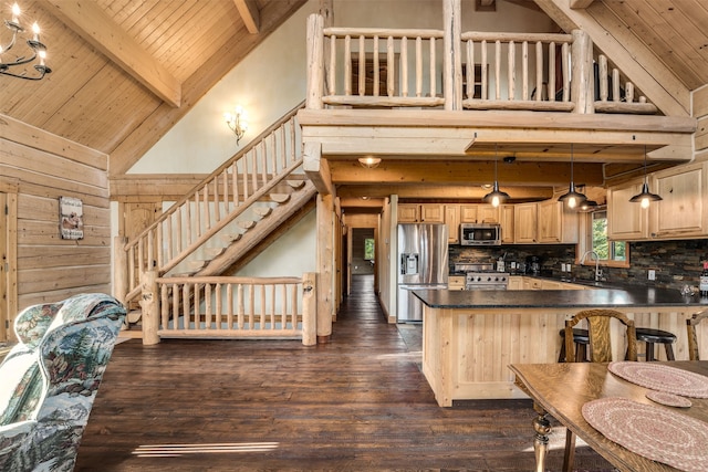 kitchen featuring stainless steel appliances, hanging light fixtures, high vaulted ceiling, and dark wood-type flooring