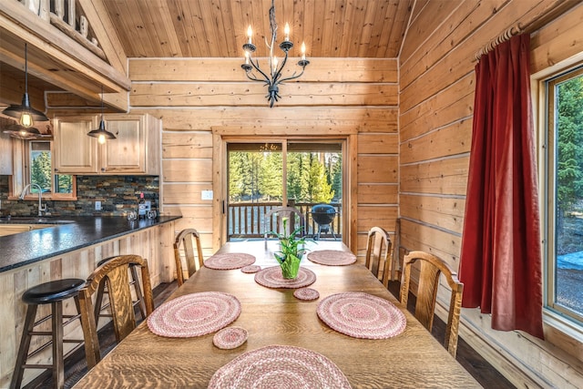 dining space with hardwood / wood-style floors, a healthy amount of sunlight, and vaulted ceiling