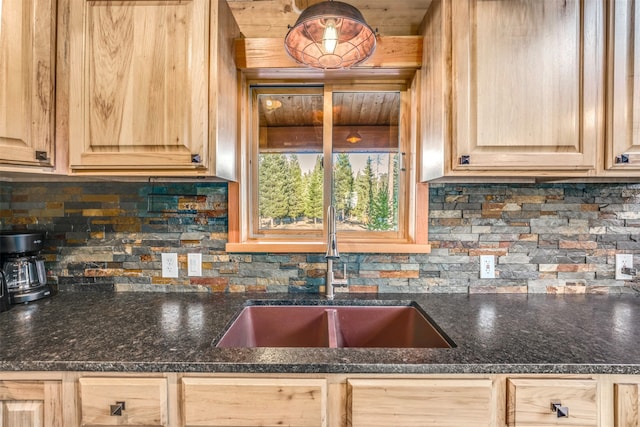 kitchen featuring dark stone countertops, decorative backsplash, sink, and light brown cabinets