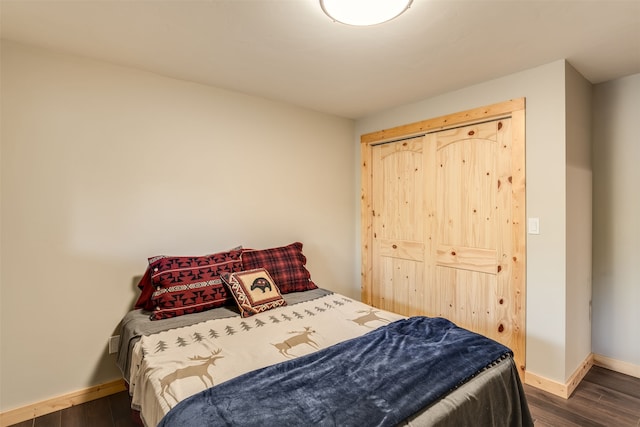 bedroom featuring dark hardwood / wood-style flooring and a closet