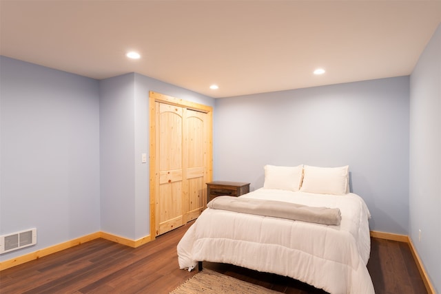 bedroom with a closet and hardwood / wood-style floors