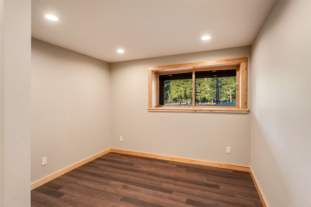 unfurnished room with dark hardwood / wood-style flooring