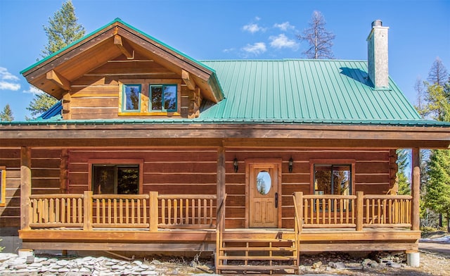 log home with covered porch