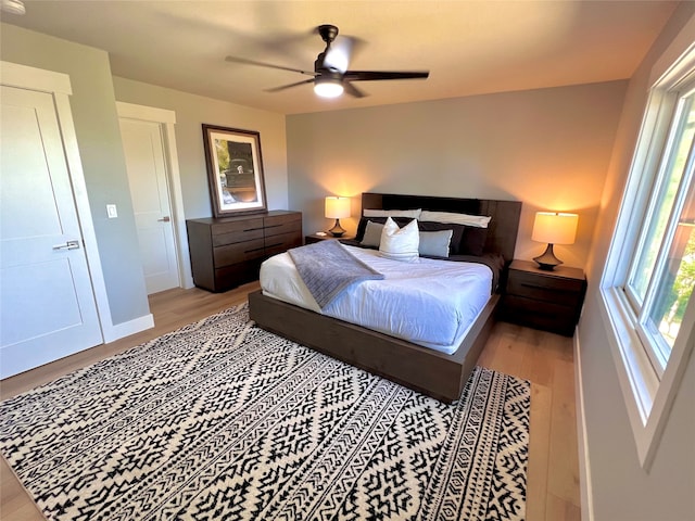 bedroom with ceiling fan and light wood-type flooring