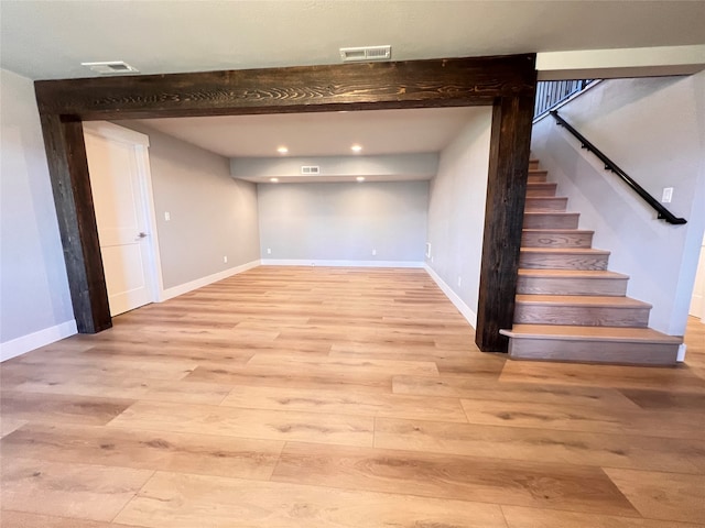 basement with light hardwood / wood-style floors