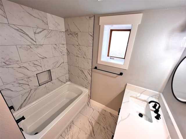 bathroom with vanity and tiled shower / bath