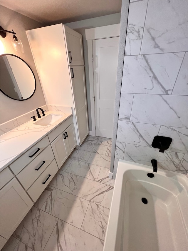 bathroom with vanity and a tub