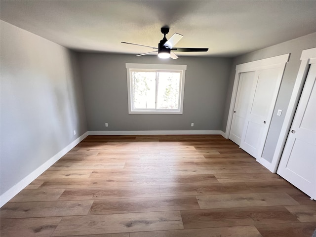 unfurnished bedroom with light wood-type flooring and ceiling fan