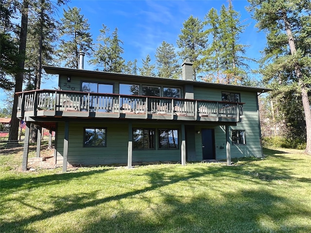 back of house with a yard and a wooden deck