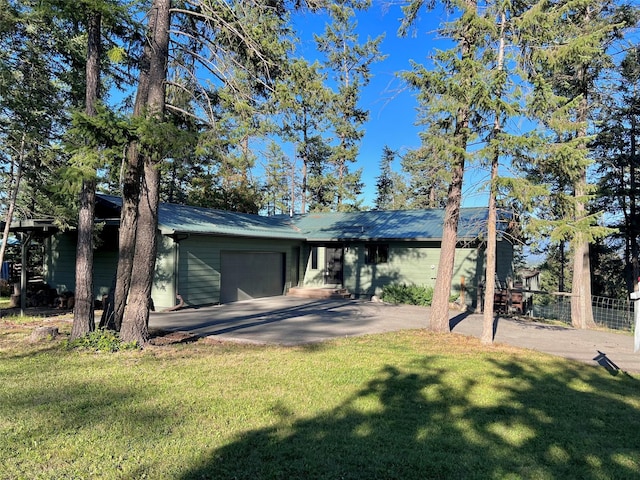 view of front of home with a front lawn and a garage