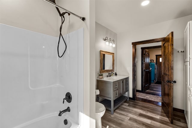 full bathroom with bathtub / shower combination, toilet, wood-type flooring, and large vanity