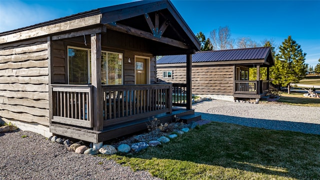 view of property exterior featuring a yard and covered porch