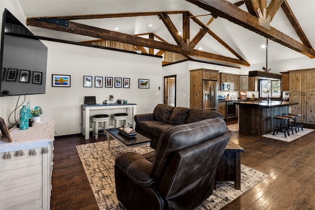 living room featuring dark hardwood / wood-style floors, high vaulted ceiling, beam ceiling, and sink