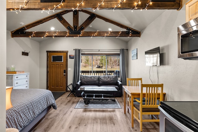 bedroom featuring light hardwood / wood-style flooring and a high ceiling