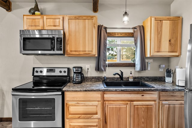 kitchen featuring pendant lighting, sink, and stainless steel appliances