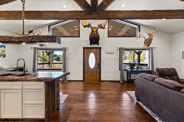 foyer with sink, high vaulted ceiling, beam ceiling, and dark hardwood / wood-style floors