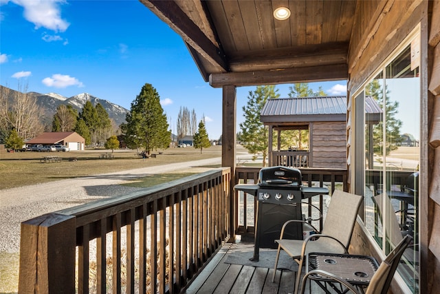 wooden terrace featuring a mountain view and area for grilling