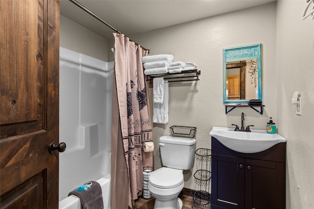 full bathroom with shower / bath combo with shower curtain, toilet, and vanity