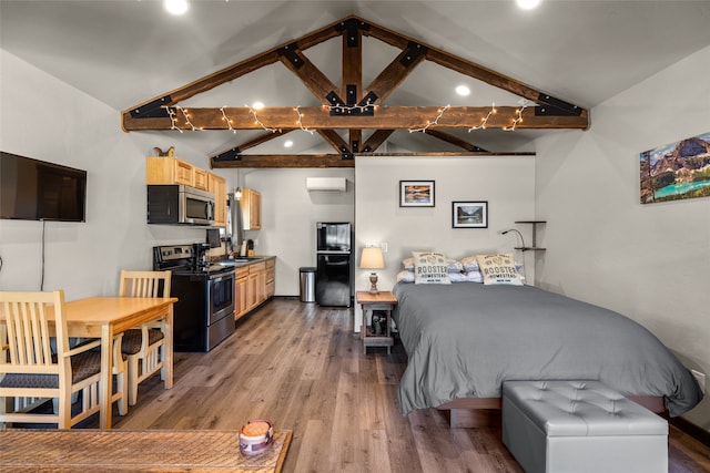 bedroom featuring light wood-type flooring, black refrigerator, an AC wall unit, sink, and lofted ceiling with beams