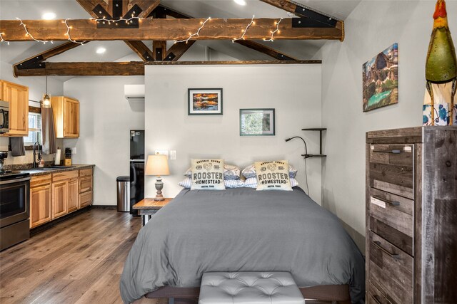 bedroom with vaulted ceiling with beams, sink, light wood-type flooring, and black refrigerator