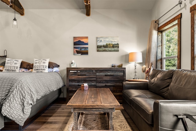 bedroom featuring dark wood-type flooring and beam ceiling