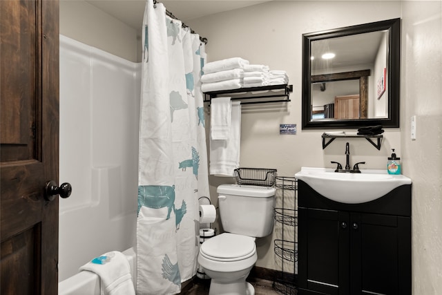 full bathroom with shower / bath combo with shower curtain, toilet, and vanity