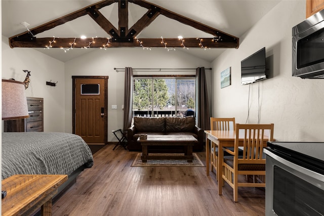 bedroom with dark hardwood / wood-style flooring and vaulted ceiling with beams