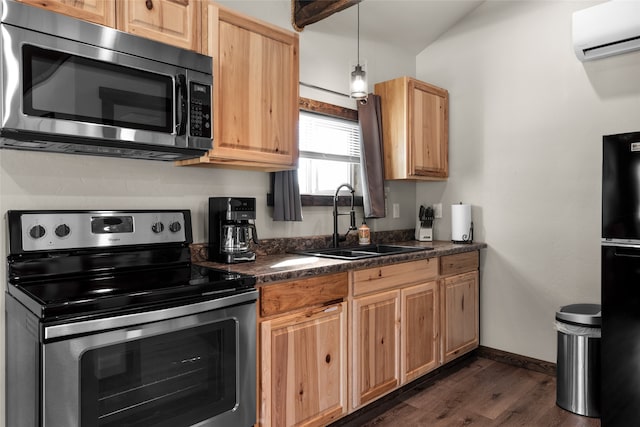 kitchen featuring stainless steel appliances, sink, dark hardwood / wood-style flooring, a wall mounted air conditioner, and decorative light fixtures