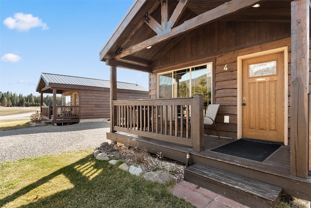 view of exterior entry featuring covered porch