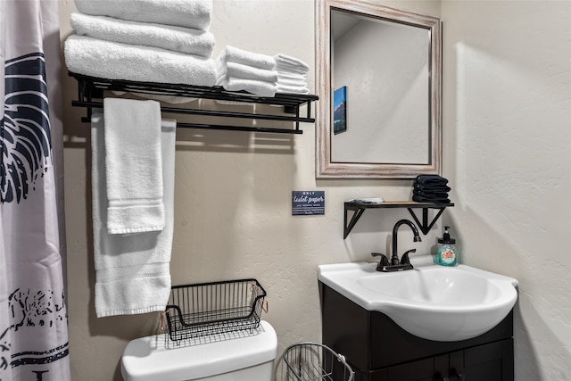 bathroom featuring toilet and vanity