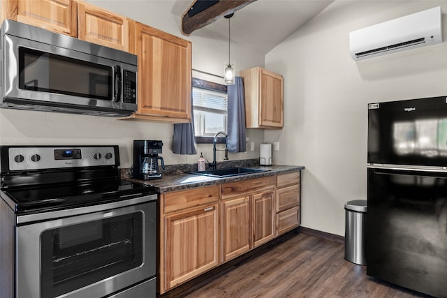 kitchen with appliances with stainless steel finishes, pendant lighting, dark wood-type flooring, a wall mounted AC, and sink