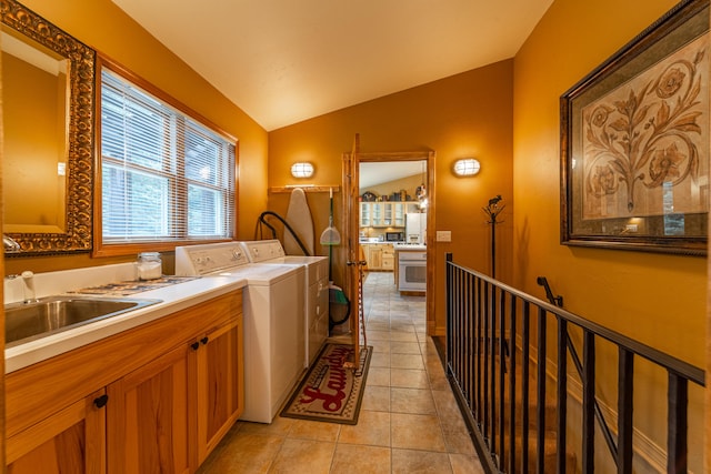 laundry area featuring sink, light tile flooring, cabinets, and separate washer and dryer