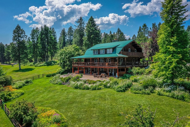 back of house with a patio area and a lawn