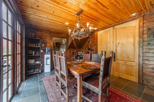 tiled dining space with log walls, a chandelier, and wood ceiling