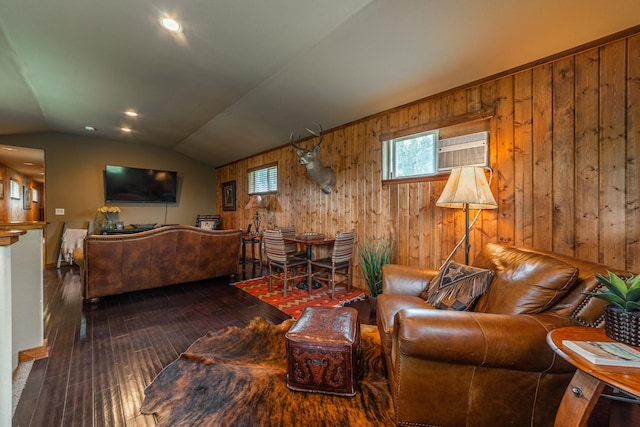 living room with lofted ceiling, dark hardwood / wood-style flooring, and wooden walls