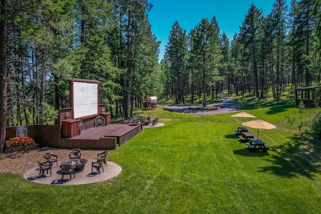 view of yard with a deck and a fire pit