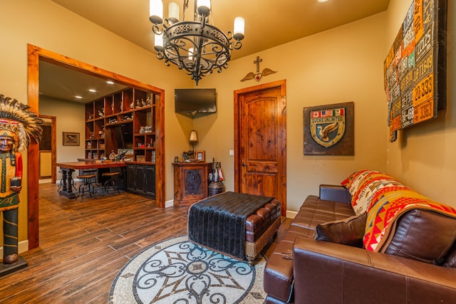 living room featuring an inviting chandelier and dark hardwood / wood-style flooring