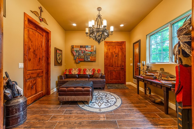 entrance foyer with dark hardwood / wood-style flooring and a notable chandelier