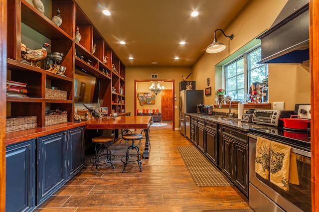 kitchen with a notable chandelier, stainless steel appliances, dark hardwood / wood-style floors, and sink