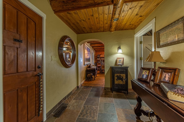 tiled entrance foyer with beamed ceiling and wooden ceiling