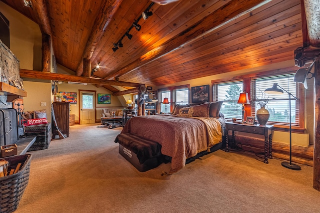 bedroom with rail lighting, beam ceiling, wood ceiling, a wood stove, and carpet