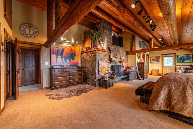 bedroom with wooden ceiling, beam ceiling, carpet, and a fireplace