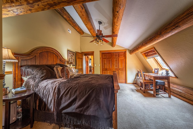 carpeted bedroom with ceiling fan and vaulted ceiling with skylight