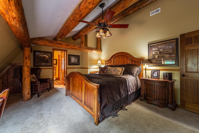 carpeted bedroom featuring beamed ceiling and ceiling fan