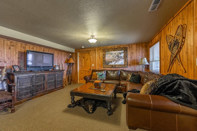 carpeted living room with wooden walls and a textured ceiling