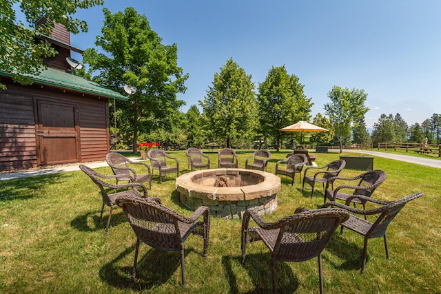 view of yard with a fire pit and a storage shed