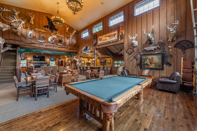 playroom featuring wood walls, dark hardwood / wood-style flooring, pool table, and high vaulted ceiling